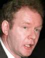 Hey what makes Martin McGuinness tick?  That alarm clock and candle combo, in his inside pocket!